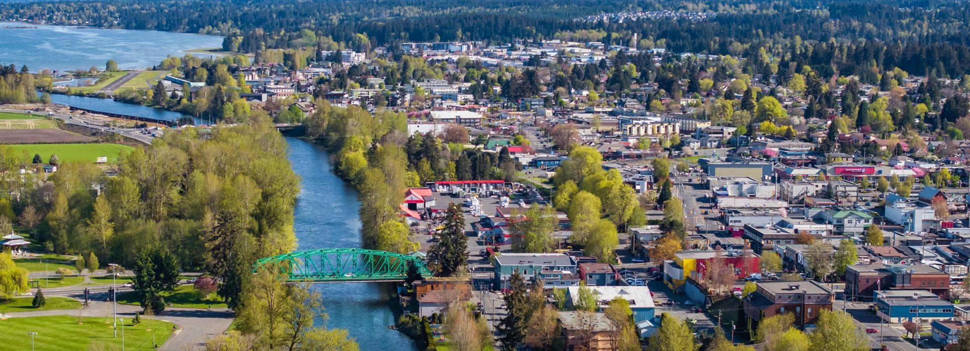 Aerial view of Courtenay with trees and buildings on a sunny day
