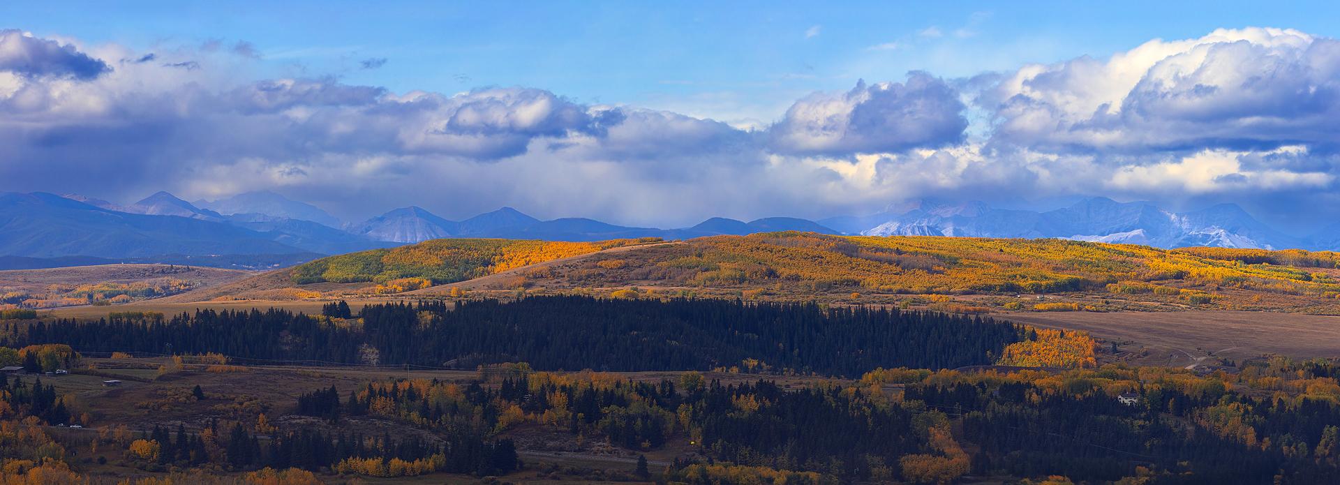 Landscape view of farm land with mountains and blue sky 