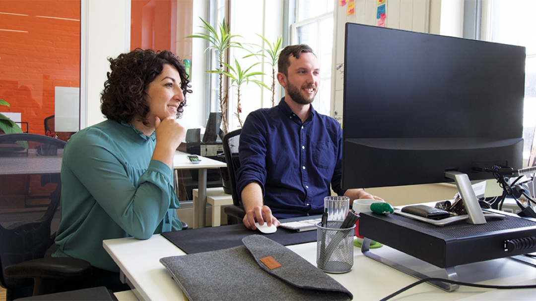 Two people working at a computer