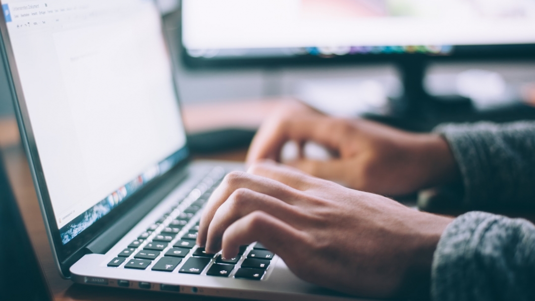 hands on a laptop