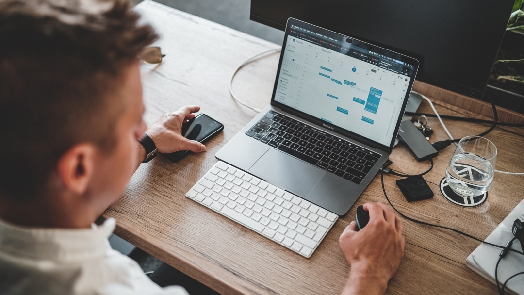 Man looking at calendar on the computer screen 