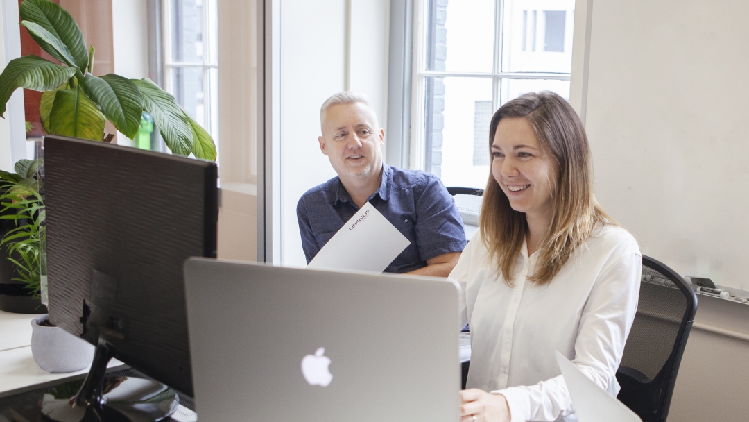 Man and women using computers 