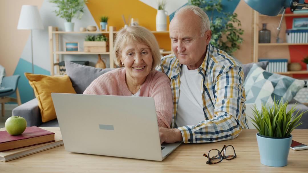 Senior couple looking at a laptop in a home environment