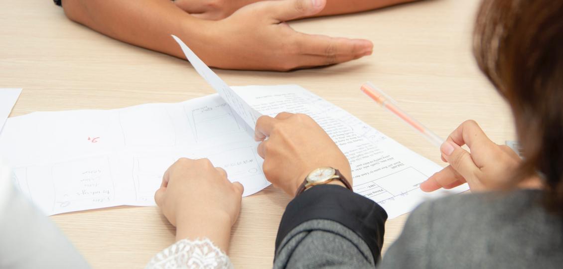 People looking at documents on a table. 