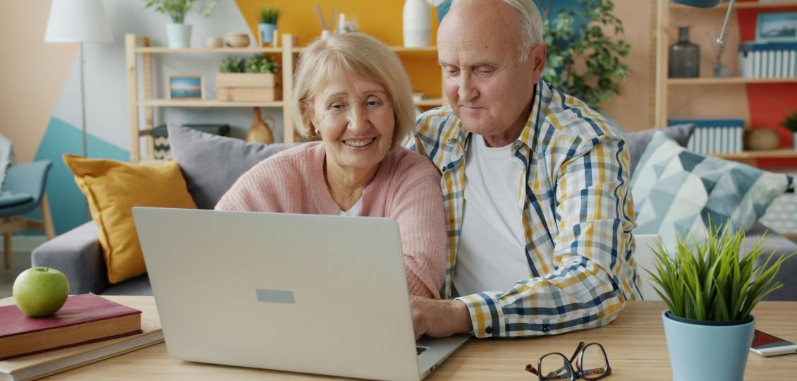 Senior couple looking at a laptop in a home environment