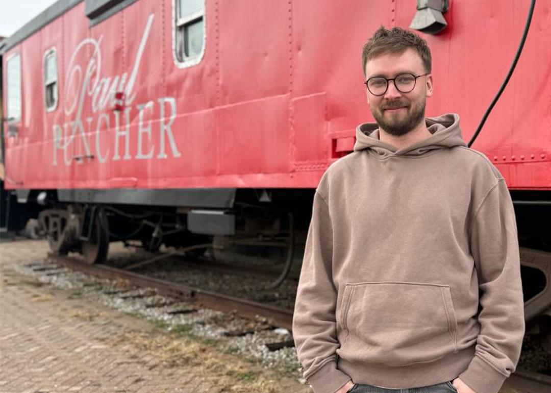 Carter standing in front of a train
